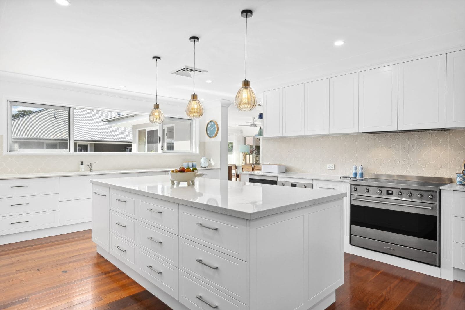 A finished white kitchen with an island